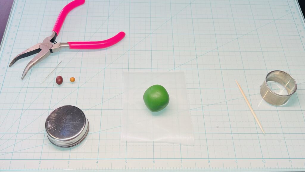 small round ball of green polymer clay on work space