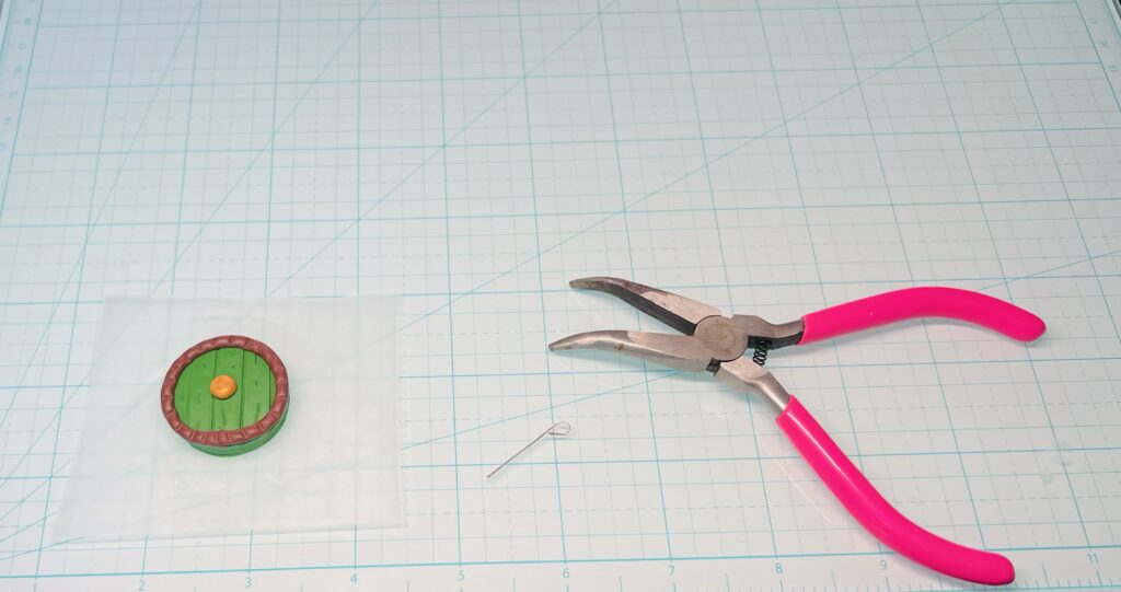 jewelry pliers and wire with a diy hook made, next to diy hobbit clay door