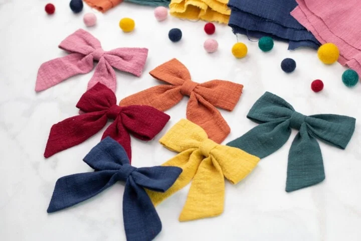 colorful sailor bows spread out on table with craft supplies