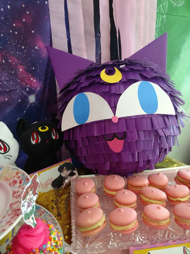 luna pinata with macarons and party decorations