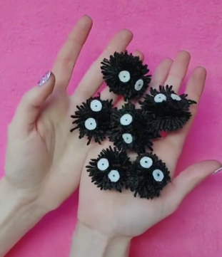 diy yarn soot sprites in hands