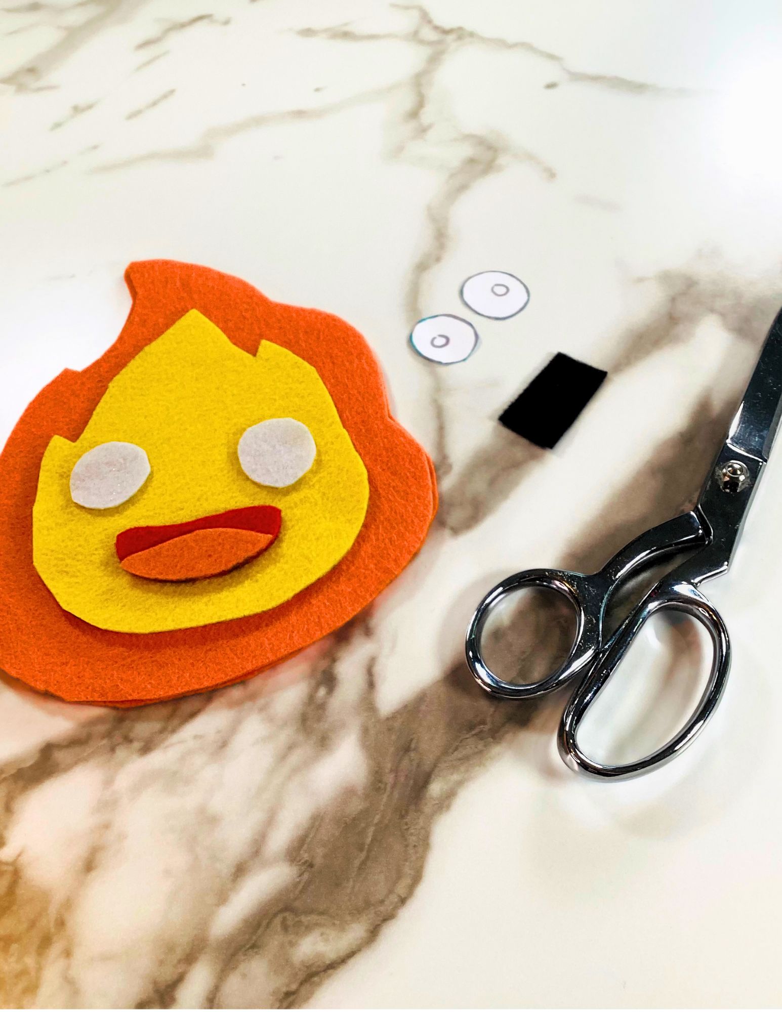 eye shapes cut and black felt square for Calcifer eyes