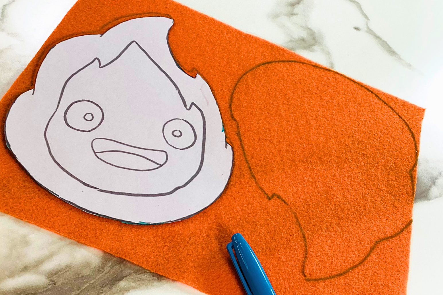 tracing Calcifer studio ghibli plushie front and back of template onto orange felt